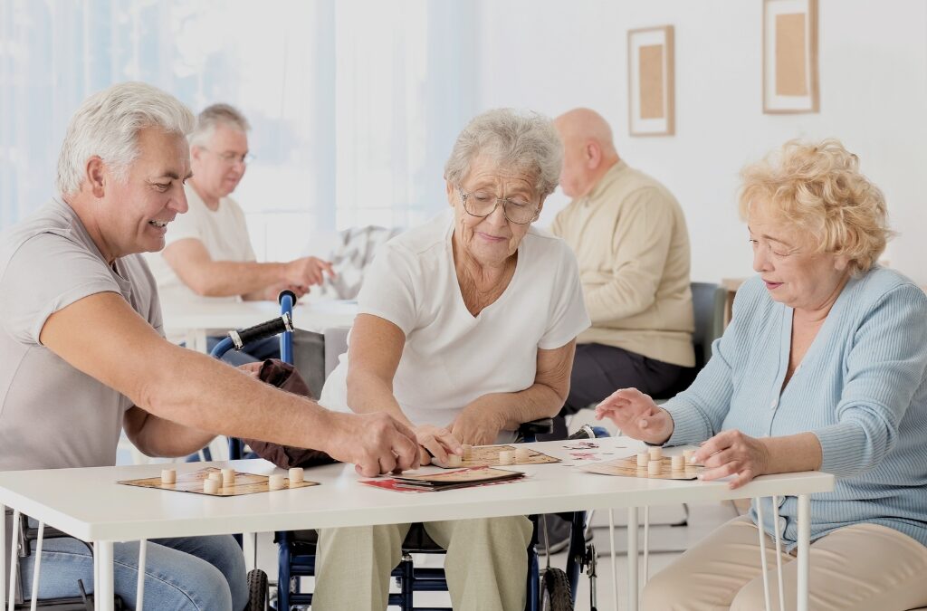 Senior couple reading email on tablet in retirement community.