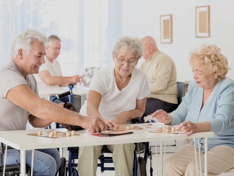Senior couple reading email on tablet in retirement community.
