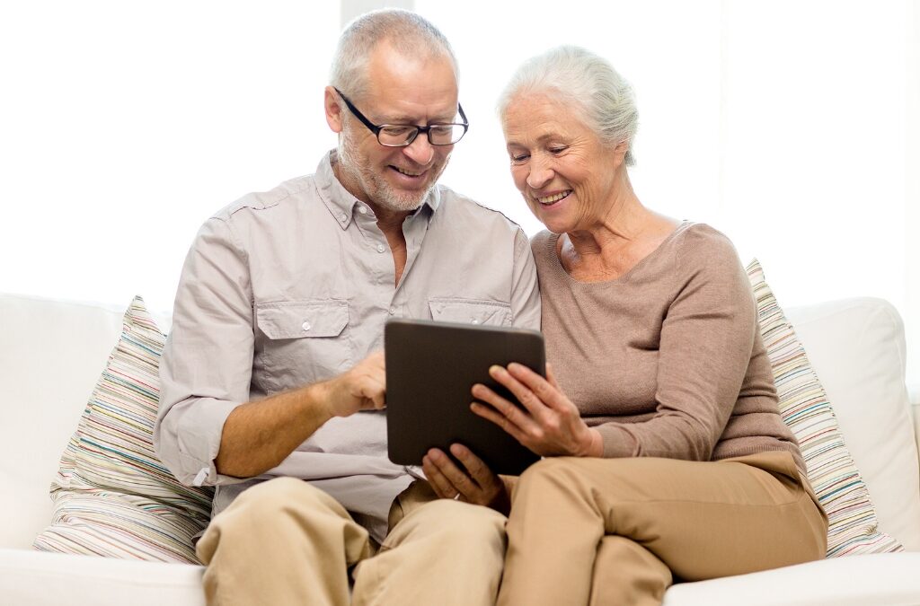 Smiling elderly woman with caregiver in a cozy assisted living home