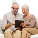Smiling elderly woman with caregiver in a cozy assisted living home