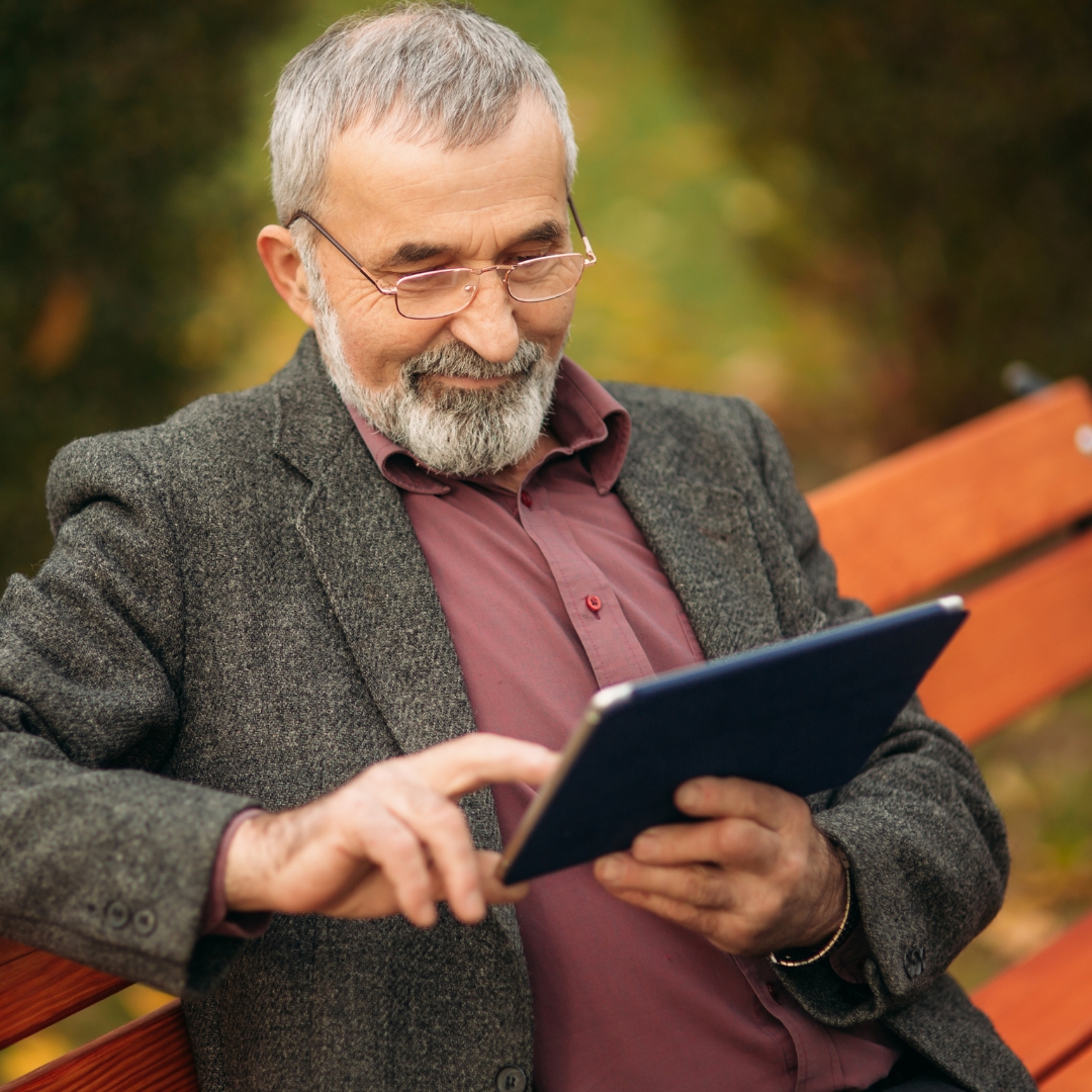 Happy senior living residents and staff in ad photo