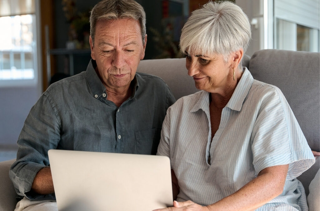Family researching senior housing options online on laptop