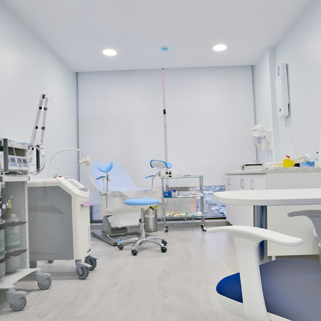 Modern treatment room at clinic with dental chair and equipment