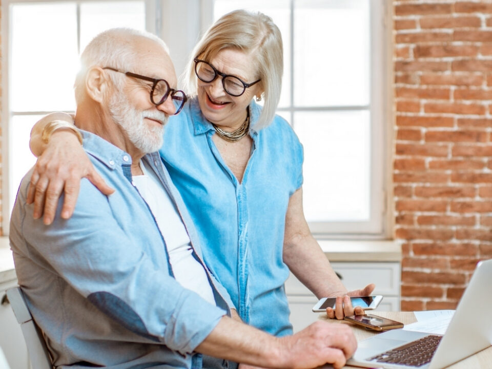 Senior using tablet in modern retirement community lounge
